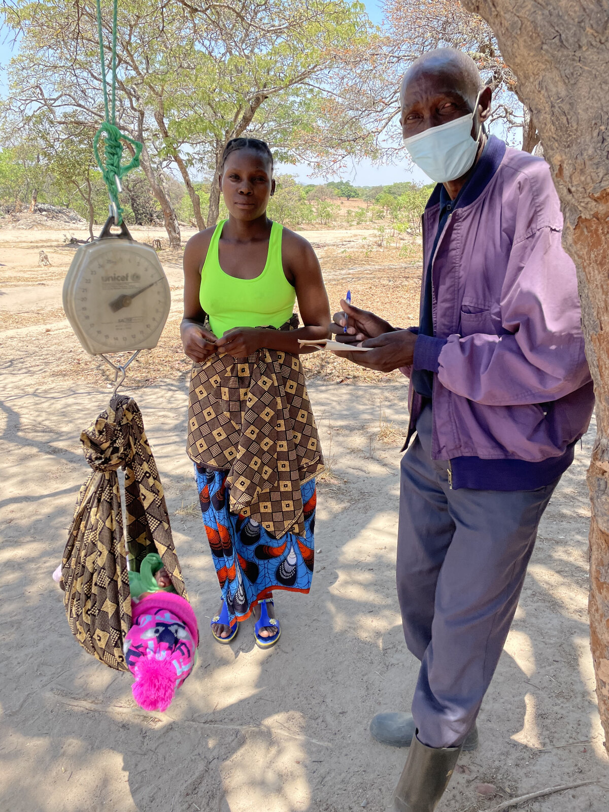 Peter weighing babies at outreach. Photo: © OCA<br>